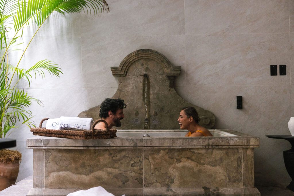 Couple enjoying a romantic moment in the outdoor stoneshower of the O:live Style Suite at O:live Boutique Hotel in Condado, San Juan, Puerto Rico.